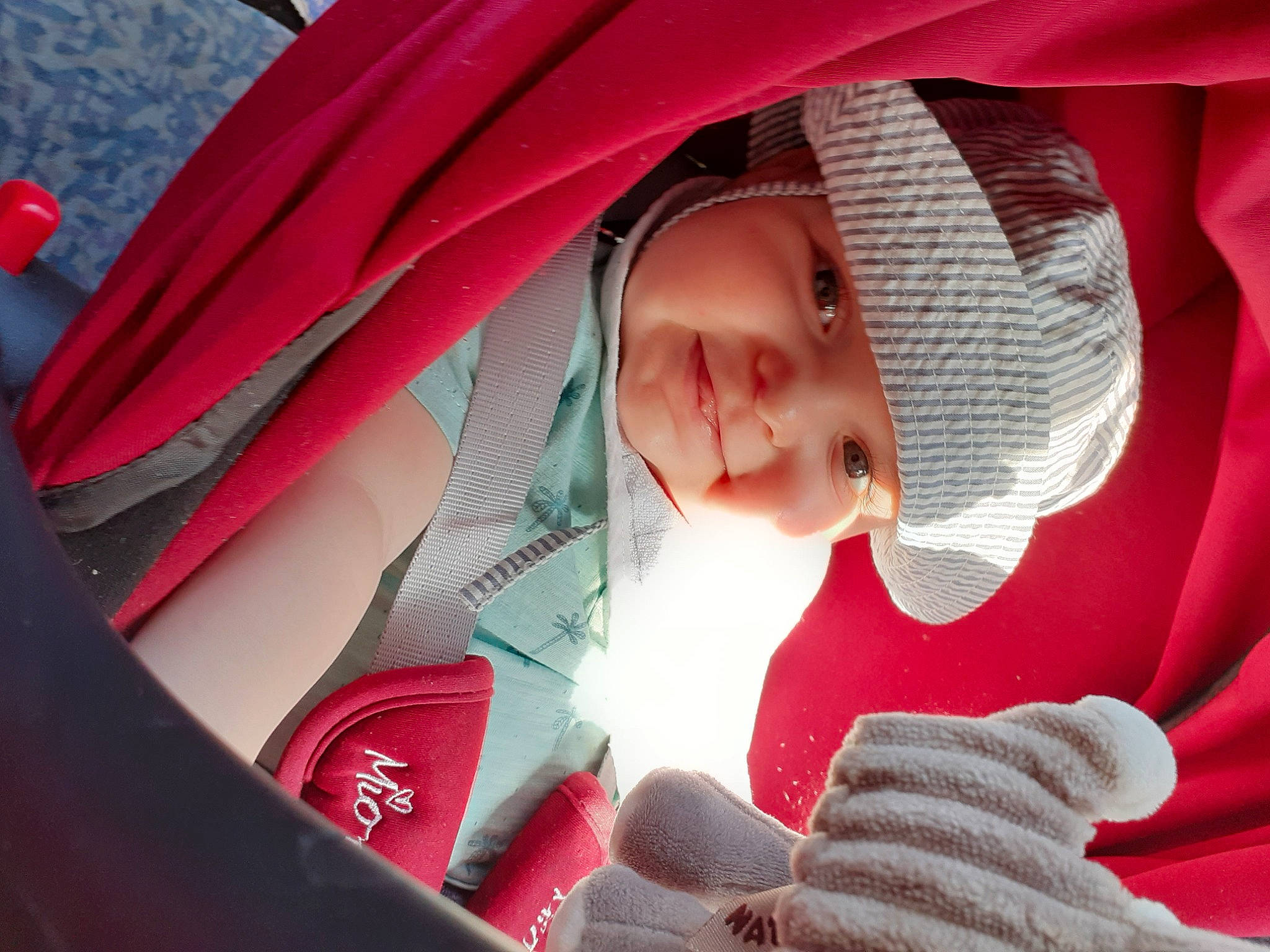 Ennio participe au concours pour gagner de l'argent avec cette photo : baby, baby_carriage, baby_products, child, comfort, eye, facial_expression, finger, glove, hat, headgear, headwear, joy, mouth, person, pink, red, skin, tints_and_shades, toddler