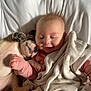 baby, puppy, blanket, bed, sleeping, cuddling, cute, infant, pet, animal, child, resting, soft, warm, comfort, pink_clothing, white_bed, polka_dot, snuggling, adorable
