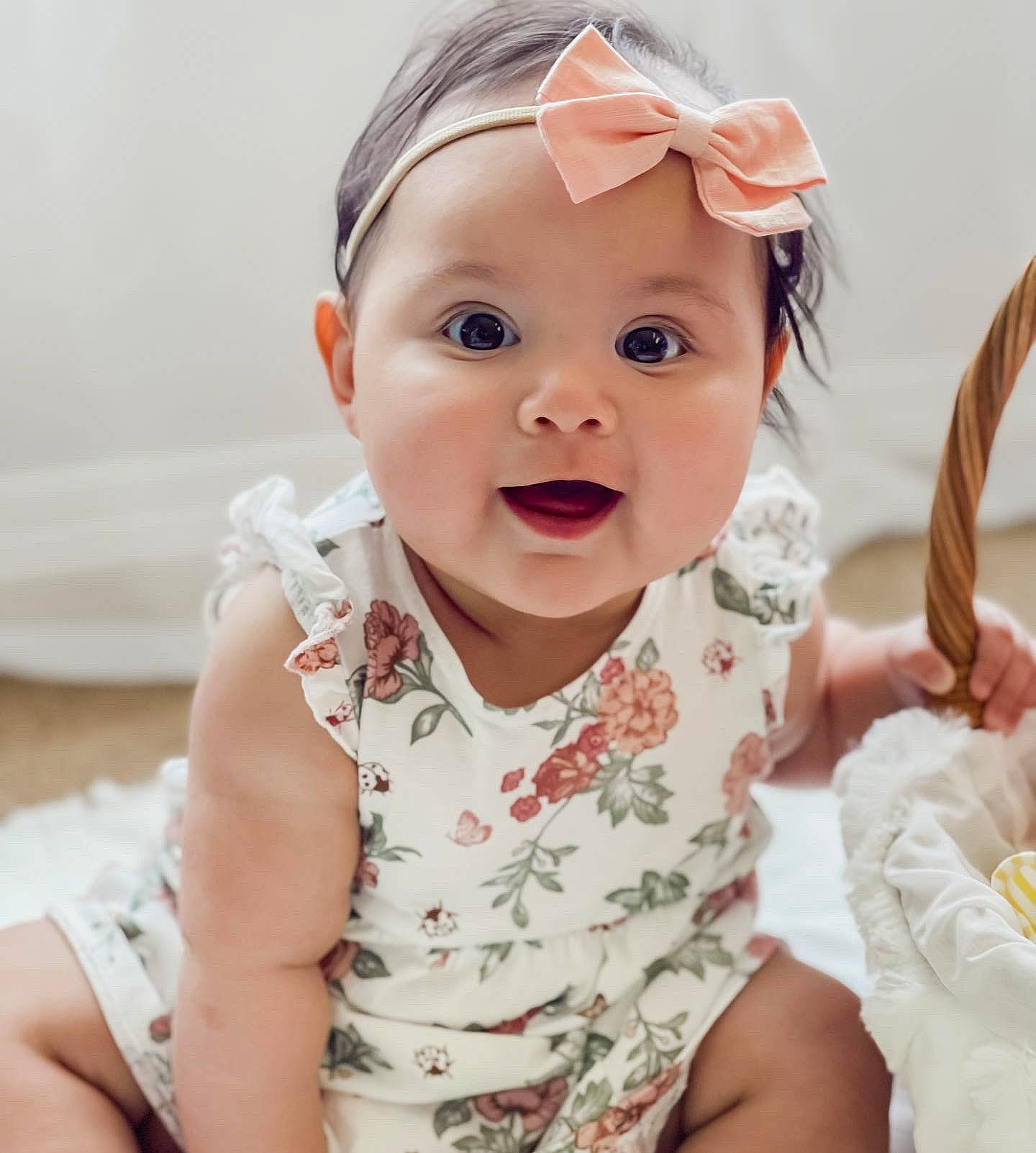 Sage is registered to the contest to win money with this photo: baby, baby_toddler_clothing, cheek, chin, eye, face, gesture, happy, head, headwear, human_body, iris, lip, mouth, neck, nose, person, pink, skin, sleeve