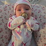 Ensley is registered to the contest to win money with this photo: baby, infant, pacifier, onesie, hat, floral, cushion, blanket, sleepwear, cute, child, newborn, resting, soft, comfort, indoors, portrait, face, hand, clothing