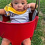 Clayton joined the competition — help win amazing prizes! baby, child, swing, red_swing, yellow_bib, outdoor, grass, greenery, infant, clothing, face, legs, metal, playground, summer, cute, portrait, expression, person, daylight