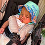 Clayton joined the competition — help win amazing prizes! baby, sleeping, stroller, bucket_hat, child, outdoor, sunlight, straps, beige, colorful, hat, infant, seatbelt, toddler, resting, peaceful, cute, person, face, closeup