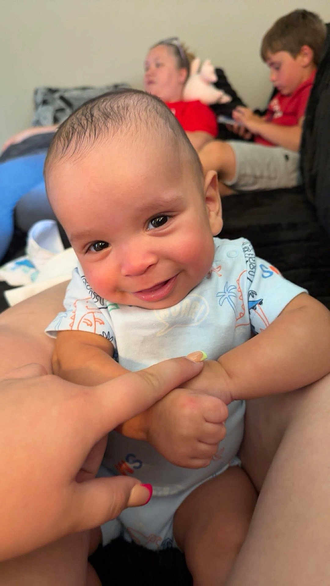 Clayton joined the competition — help win amazing prizes! baby, smiling, child, infant, person, hand, finger, couch, indoor, family, woman, boy, casual, clothing, relaxing, background, playful, skin, expression, seated