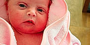 Sienna joined the competition — help win amazing prizes! baby, child, close_up, cute, eyes, face, floor, fresh, hooded_towel, indoor, infant, newborn, person, pink_towel, portrait, skin, soft_texture, wooden_floor, wrapped, young