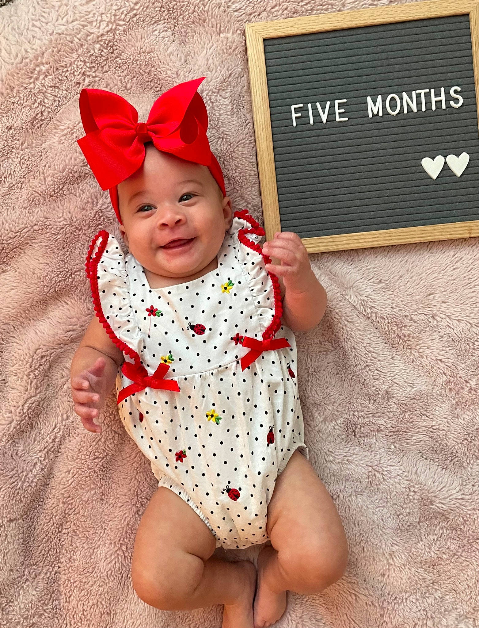 Kendall is registered to the contest to win money with this photo: baby, baby_toddler_clothing, child, costume_hat, fashion_accessory, finger, foot, gesture, happy, headwear, human_body, human_leg, joy, nail, pattern, person, pink, skin, sleeve, textile