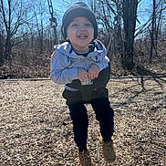 Dario joined the competition — help win amazing prizes! child, toddler, swing, playground, outdoor, smiling, happy, clothing, hoodie, beanie, shoes, tree, woodchips, sunny, sky, nature, person, fun, play, winter