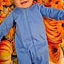 baby, child, smiling, blue_onesie, pumpkin, sunflower, autumn, blanket, happy, cute, infant, face, lying_down, fall, seasonal, cozy, portrait, person, orange, yellow