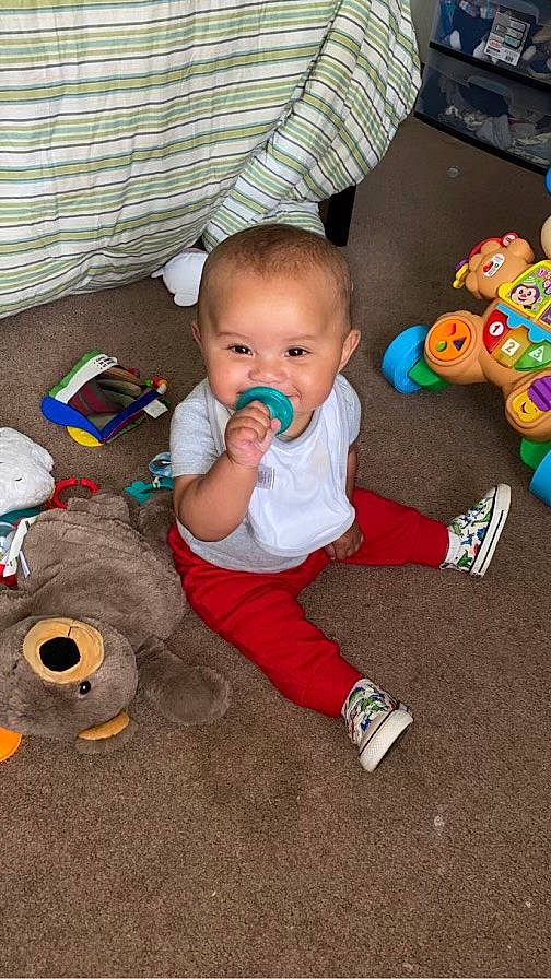 Zaylin is registered to the contest to win money with this photo: automotive_tire, baby, baby_products, baby_toddler_clothing, baby_toys, child, comfort, floor, flooring, fun, hardwood, person, play, room, sitting, stuffed_toy, tire, toddler, toy, wood