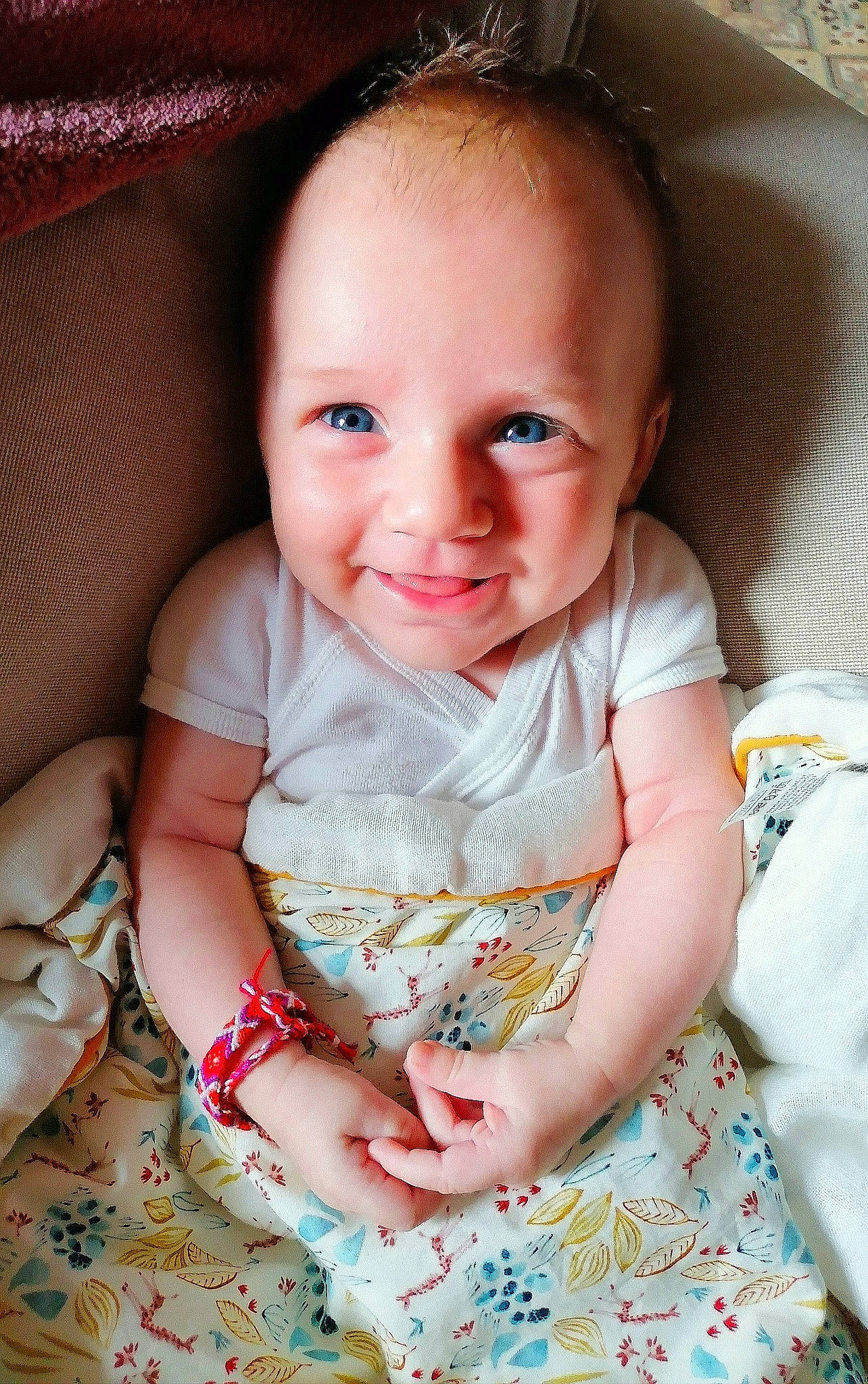 Louise participe au concours pour gagner de l'argent avec cette photo : baby, baby_toddler_clothing, cheek, child, comfort, dress, finger, hair, happy, head, joy, linens, pattern, people, person, pink, sitting, skin, sleeve, smile