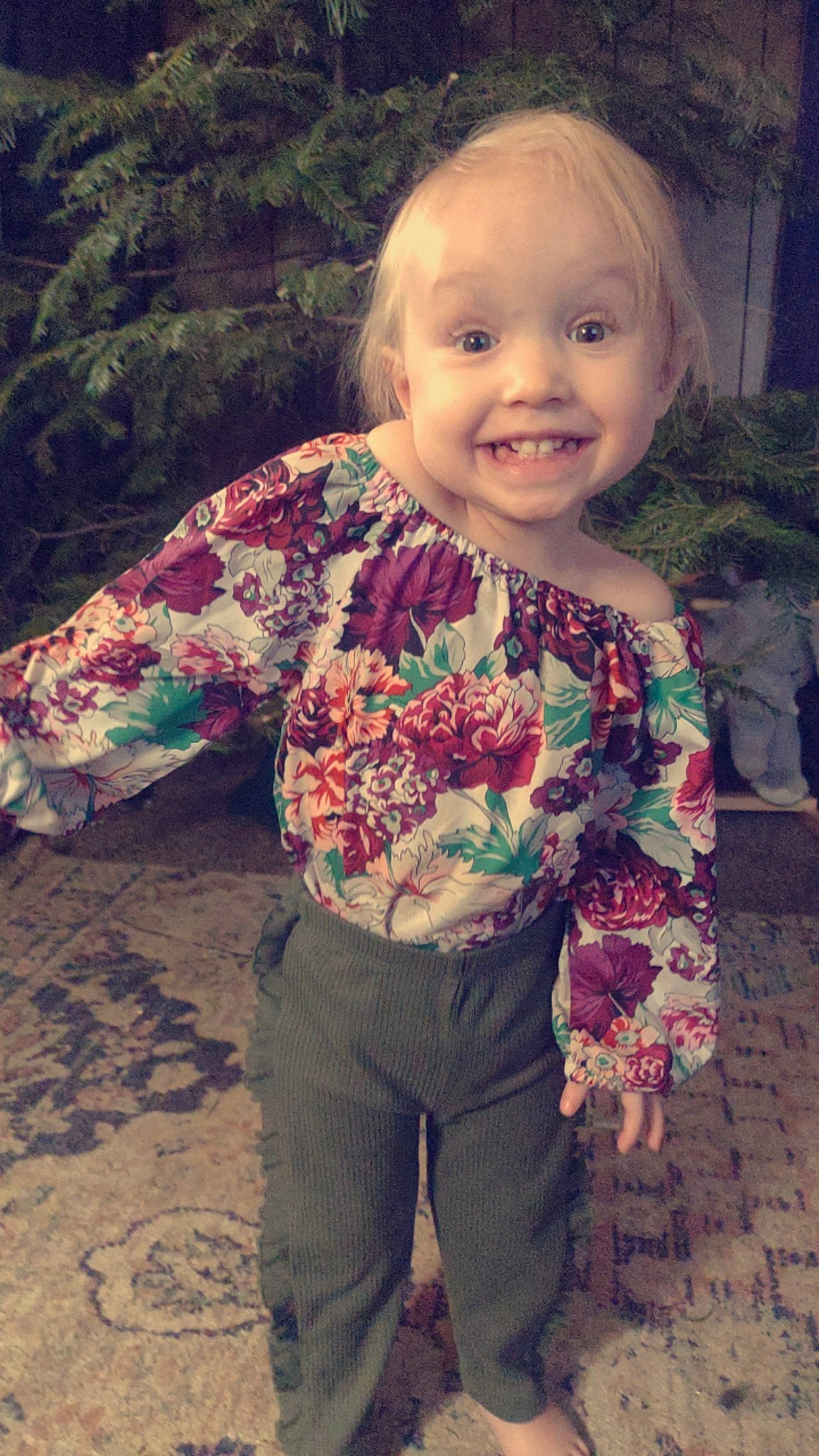 Athenna is registered to the contest to win money with this photo: arm, baby_toddler_clothing, cheek, face, facial_expression, hairstyle, happy, head, human, iris, joy, leaf, organ, people_in_nature, person, plant, skin, sleeve, smile, standing