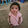 Neena is registered to the contest to win money with this photo: baby, child, smiling, indoor, carpet, pink_dress, curly_hair, toy, furniture, floor, cute, portrait, happy, toddler, playroom, person, sitting, childhood, infant, young