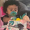 Neena is registered to the contest to win money with this photo: baby, black_hair, cake, celebration, child, curly_hair, face_paint, food, frosting, fun, high_chair, indoor, living_room, messy, person, pink, sippy_cup, smearing, toddler, white_clothing