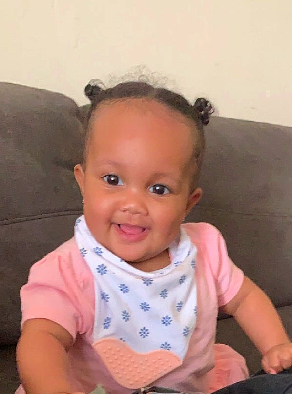 Brynnlee is registered to the contest to win money with this photo: baby, baby_toddler_clothing, cheek, child, chin, ear, eye, face, forehead, head, iris, joy, lip, mouth, neck, nose, person, pink, sitting, skin