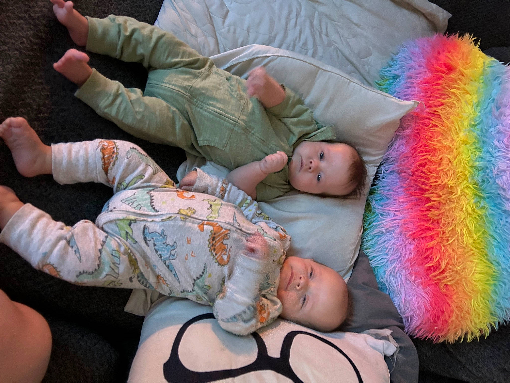 Dennis And James is registered to the contest to win money with this photo: baby, baby_toddler_clothing, camouflage, child, comfort, event, eye, fun, gesture, green, human_body, human_leg, knee, lap, military_camouflage, person, sitting, skin, thigh, thumb