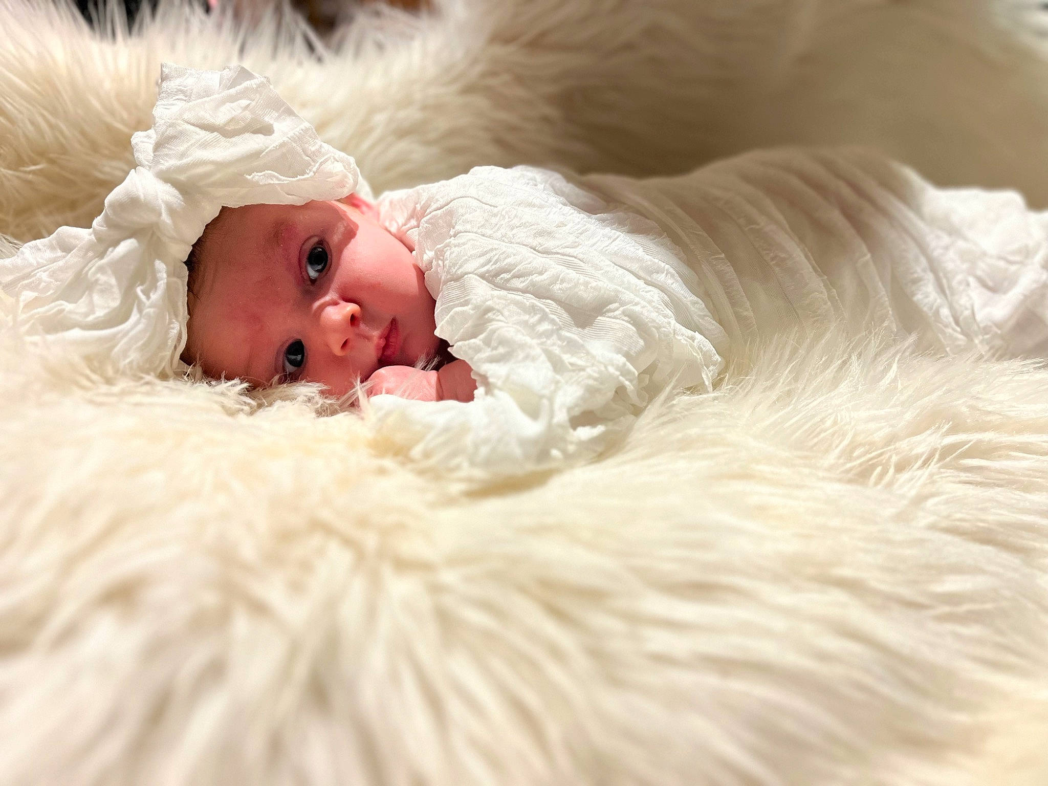 Charli is registered to the contest to win money with this photo: baby, bedtime, bridal_accessory, comfort, event, eye, fashion_accessory, feather, fur, fur_clothing, happy, hat, head, headwear, linens, nap, peach, person, petal, portrait_photography