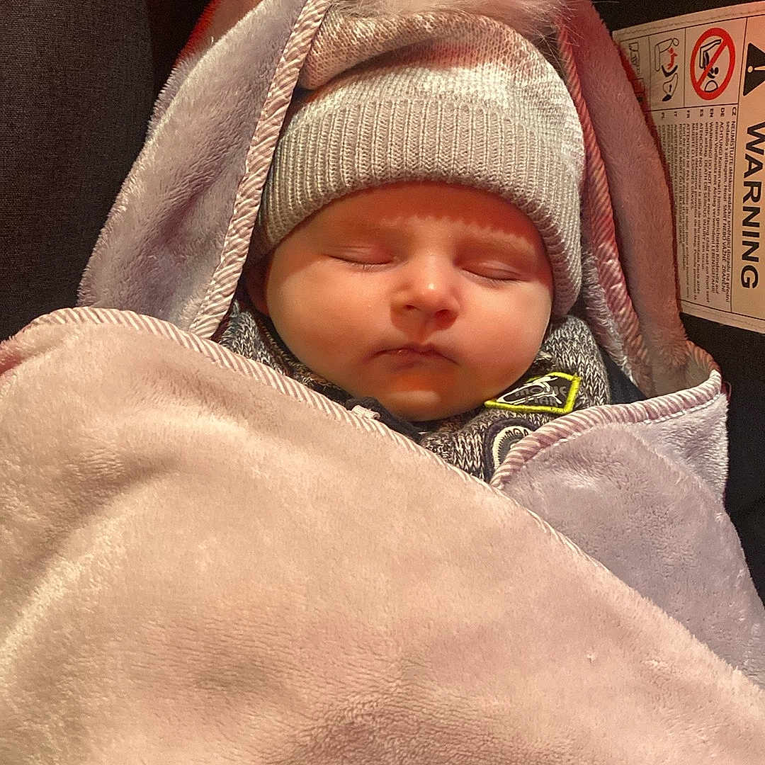 Oliver a rejoint le concours — aidez-le/la à gagner de superbes lots ! baby, bear_design, blanket, bundle, car_seat, child, closed_eyes, comfort, cozy, cute, face, hat, headwear, infant, pom_pom, rest, sleeping, soft_texture, warm, warning_label