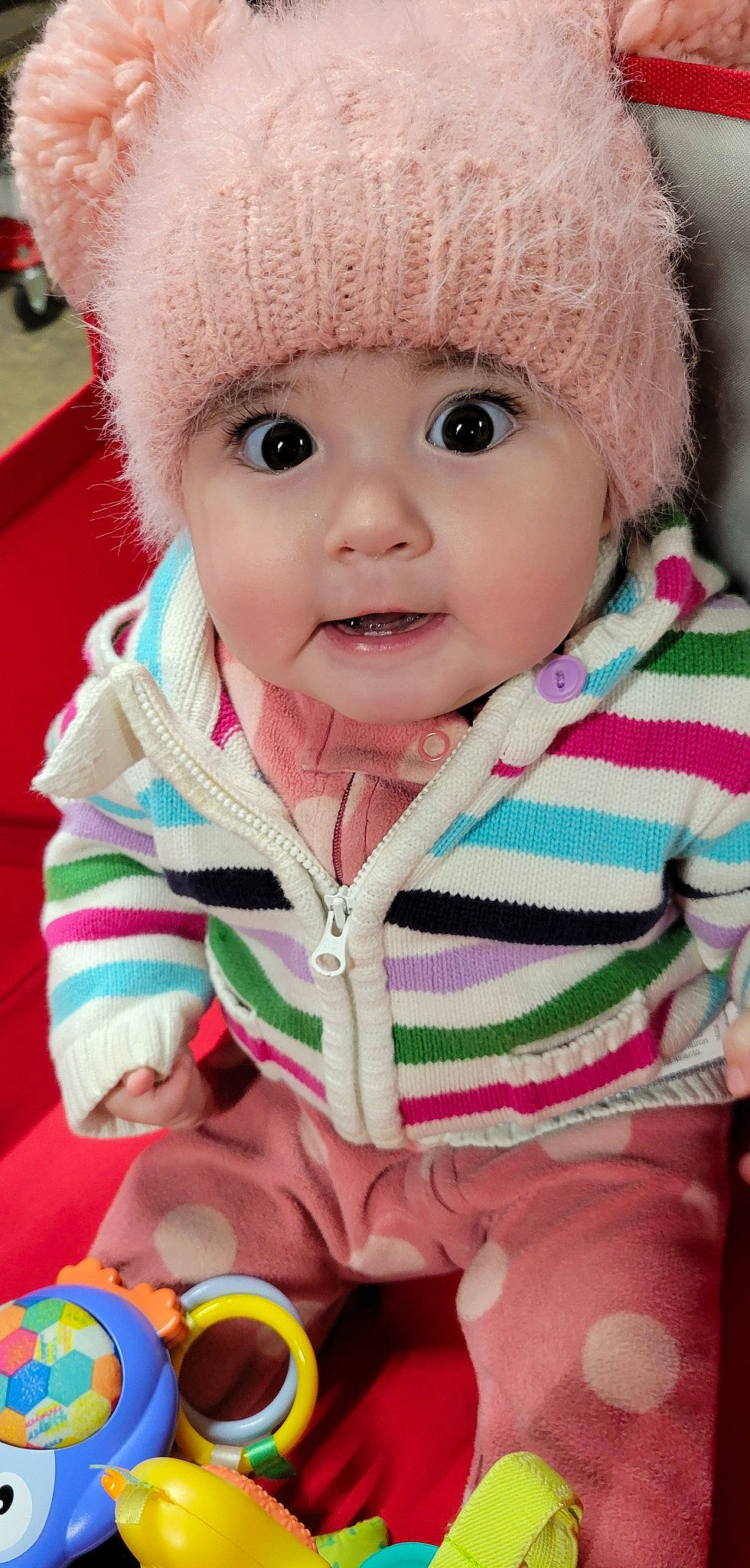 Hailee is registered to the contest to win money with this photo: baby, baby_toddler_clothing, cap, cheek, child, eyelash, green, happy, headwear, human_body, iris, jacket, lip, nose, organ, outerwear, person, pink, skin, sleeve
