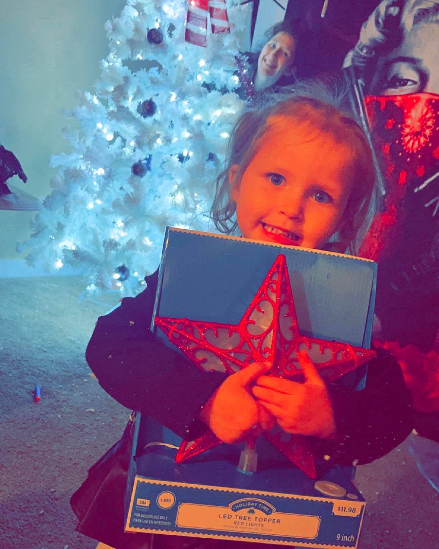 Alazae is registered to the contest to win money with this photo: child, christmas, christmas_decoration, christmas_eve, christmas_ornament, christmas_tree, electric_blue, event, fun, happy, holiday, holiday_ornament, joy, lap, ornament, person, sitting, smile, snapshot, standing