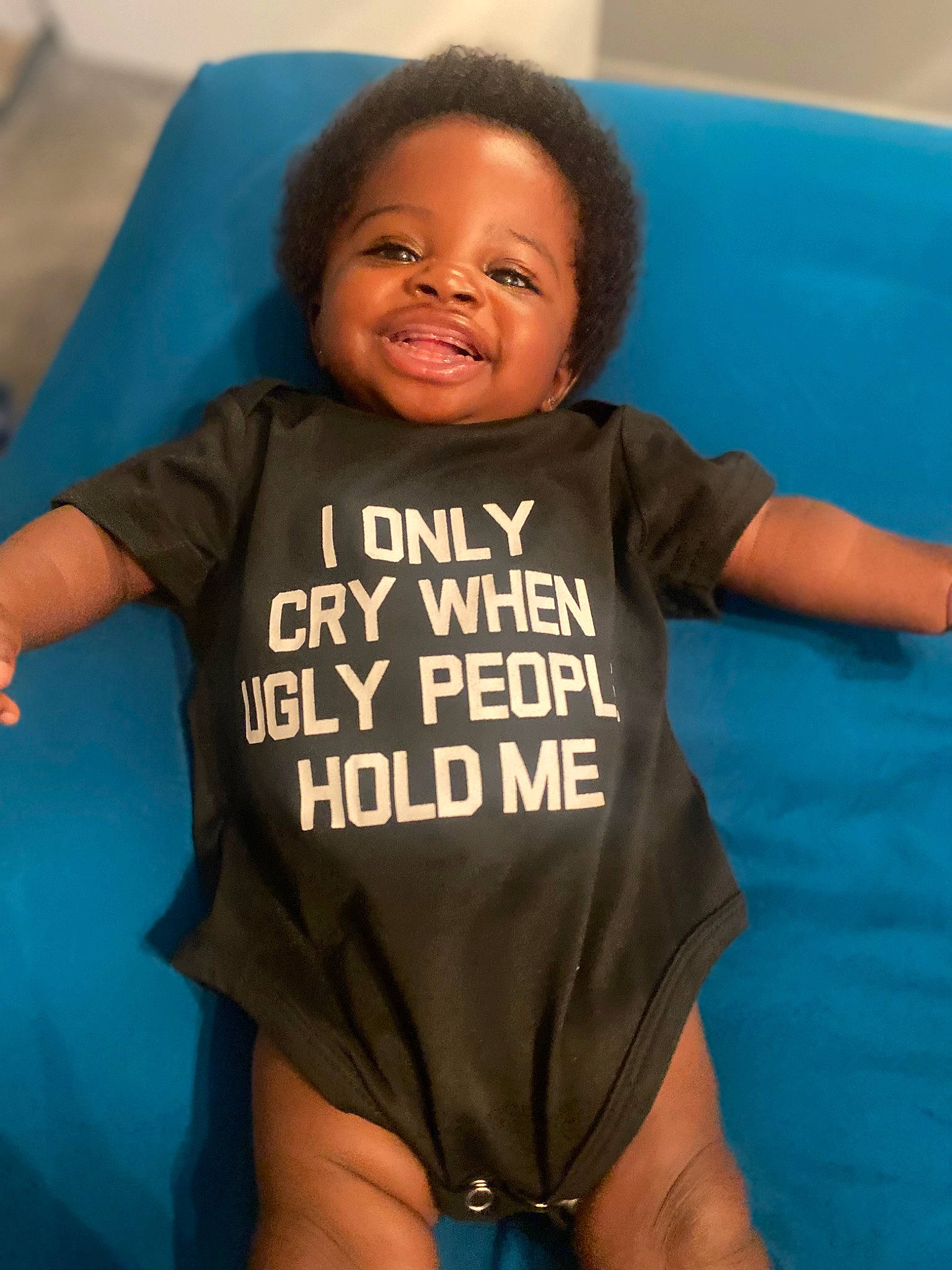 A Riyah is registered to the contest to win money with this photo: baby, baby_toddler_clothing, comfort, face, facial_expression, gesture, hair, hairstyle, happy, head, human_body, joy, leisure, mouth, neck, person, skin, sleeve, smile, t_shirt