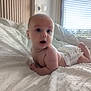 Louis a rejoint le concours — aidez-le/la à gagner de superbes lots ! baby, infant, diaper, bed, white_bedspread, curious, open_mouth, natural_light, window, blinds, indoor, soft_texture, skin, child, cute, young, lying_down, room, peaceful, cozy