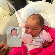 Namylah is registered to the contest to win money with this photo: baby, infant, newborn, photo_card, hand, blanket, mittens, pink, white, striped_clothing, bed, cushion, portrait, indoor, person, cute, sleeping_baby, photography, family, soft