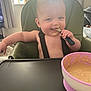 Arlo joined the competition — help win amazing prizes! baby, high_chair, feeding, spoon, food, bowl, smiling, infant, cute, indoors, child, face, messy, happy, kitchenware, person, seat, mealtime, home, curtain