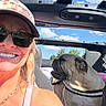That Bulldog Buck is registered to the contest to win money with this photo: blonde_hair, blue_sky, bulldog, car, clouds, convertible, dog, harness, hat, outdoor, person, pet, portrait, road_trip, seated, selfie, smiling, sunglasses, sunny, woman