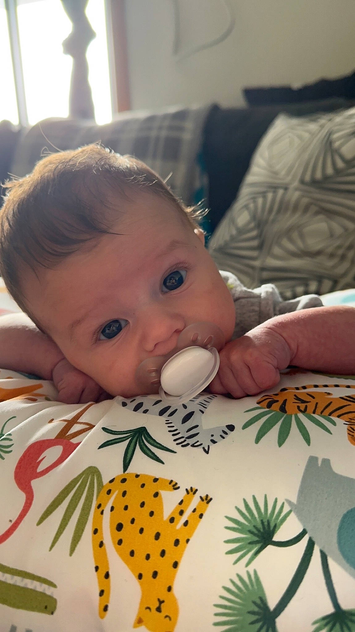 Cooper is registered to the contest to win money with this photo: baby, baby_products, baby_toddler_clothing, cheek, child, comfort, drinkware, flooring, grass, happy, linens, lip, nail, pattern, person, room, sitting, skin, toddler, white