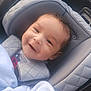 Ezmari joined the competition — help win amazing prizes! baby, child, smiling, blanket, car_seat, clothing, face, head, person, seat, comfort, cute, infant, portrait, baby_boy, happy, cozy, curly_hair, indoor, soft