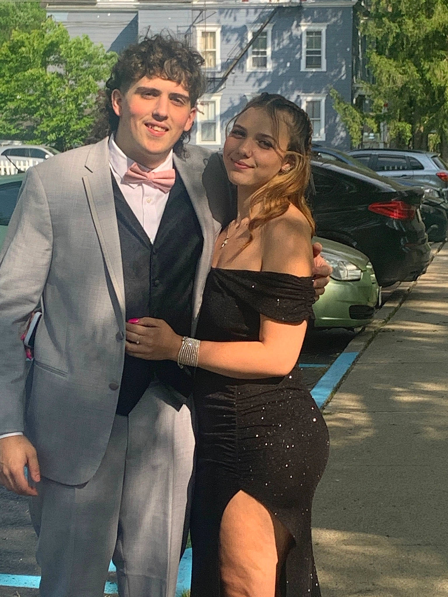 Gabriella is registered to the contest to win money with this photo: belt, blazer, car, chest, event, eyewear, fashion_design, formal_wear, fun, gesture, hairstyle, joy, necklace, person, personal_luxury_car, smile, style, suit, thigh, tire