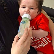 Legion joined the competition — help win amazing prizes! baby, infant, child, bottle, feeding, red_outfit, indoors, portrait, face, hair, hand, adult, holding, sofa, office_chair, floor, furniture, casual, photograph, family