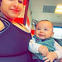 Baby Jose joined the competition — help win amazing prizes! woman, baby, smile, indoor, tattoo, clothing, vest, jeans, face, person, holding, seated, ceiling, light, window, red_wall, white_wall, happy, casual, portrait