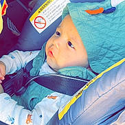 Baby Jose joined the competition — help win amazing prizes! baby, child, car_seat, seatbelt, hooded_vest, clothing, infant, safety_warning, vehicle_interior, side_view, cute, young_child, seat, straps, portrait, indoors, baby_boy, casual_wear, headwear, serious_expression