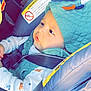 baby, child, car_seat, seatbelt, hooded_vest, clothing, infant, safety_warning, vehicle_interior, side_view, cute, young_child, seat, straps, portrait, indoors, baby_boy, casual_wear, headwear, serious_expression