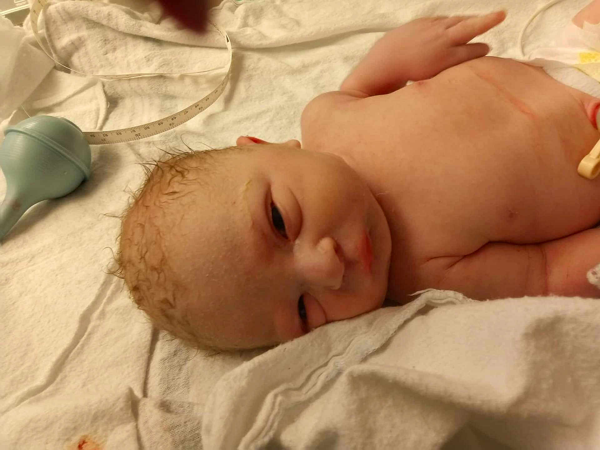 Hayden joined the competition — help win amazing prizes! baby, newborn, infant, blanket, towel, hospital, suction_bulb, measuring_tape, umbilical_clamp, wet_hair, face, eyes, nose, chest, arm, skin, lying_on_back, medical, hospital_bed, newborn_care