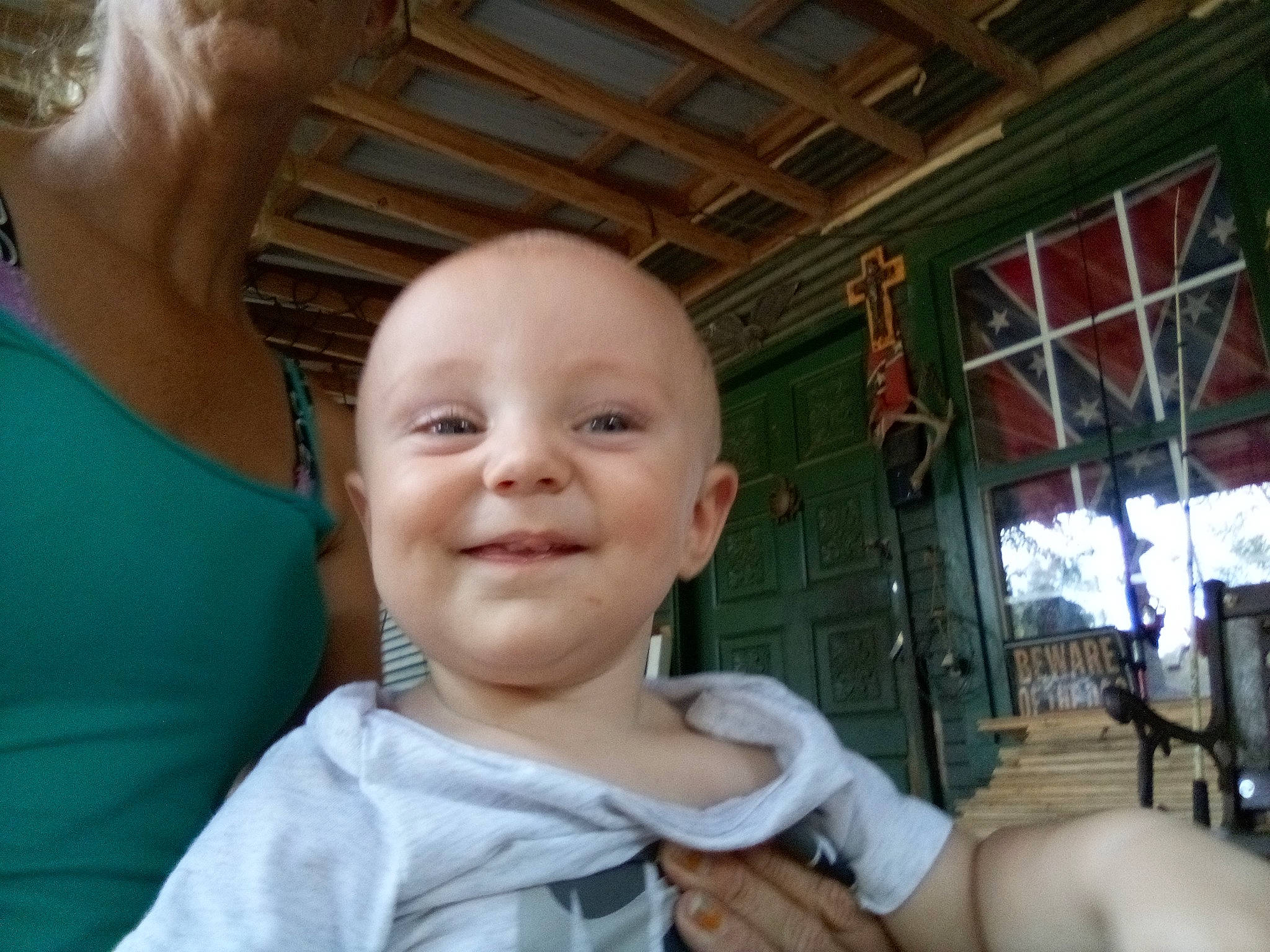 Cameron is registered to the contest to win money with this photo: baby, baby_toddler_clothing, cheek, child, ear, finger, fun, gesture, happy, joy, leisure, mammal, mouth, nose, person, sitting, skin, smile, t_shirt, thumb