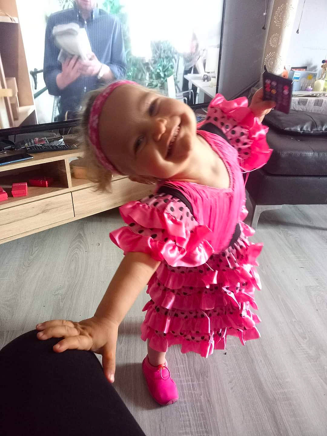 Analia participe au concours pour gagner de l'argent avec cette photo : baby, baby_toddler_clothing, child, dress, event, flooring, fun, happy, hardwood, hat, headwear, joy, magenta, person, pink, purple, shoulder, sitting, skin, smile
