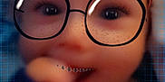 Tyberius is registered to the contest to win money with this photo: child, face, glasses, headband, red, freckles, smile, hand, blur, digital_filter, portrait, closeup, background_grid, eyewear, young, cute, indoor, expression, person, fashion_accessory