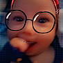 child, face, glasses, headband, red, freckles, smile, hand, blur, digital_filter, portrait, closeup, background_grid, eyewear, young, cute, indoor, expression, person, fashion_accessory