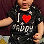 Tyberius is registered to the contest to win money with this photo: baby, black_clothing, blanket, child, cute, expression, face, hand, head, heart, indoor, infant, person, portrait, purple_cushion, sitting, star_wars, stars, text_on_clothing, wide_eyes