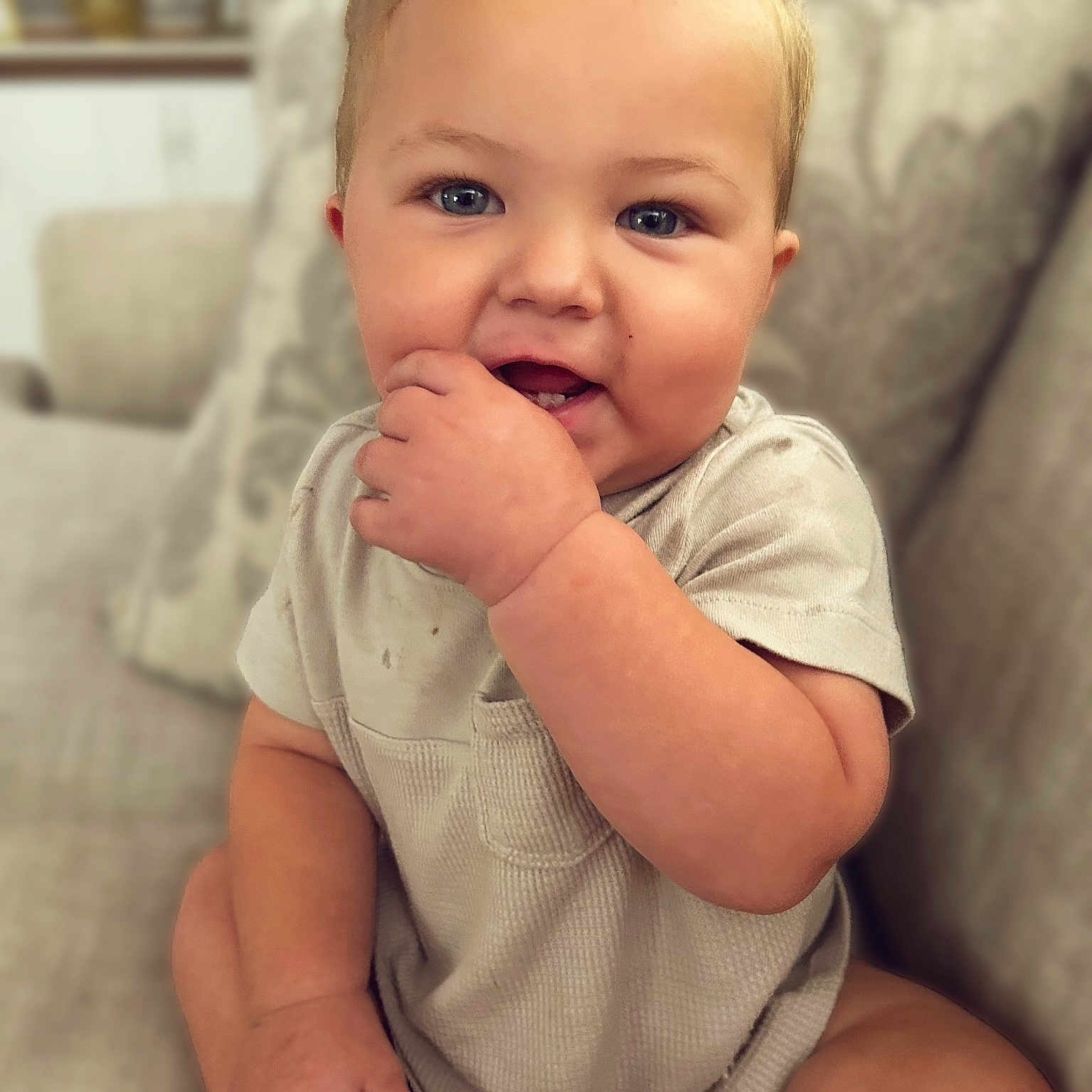 Brooks joined the competition — help win amazing prizes! baby, blue_eyes, child, clothing, couch, cushion, cute, face, fingers, furniture, hand, happy, home, indoor, infant, portrait, short_sleeves, sitting, smiling, sofa
