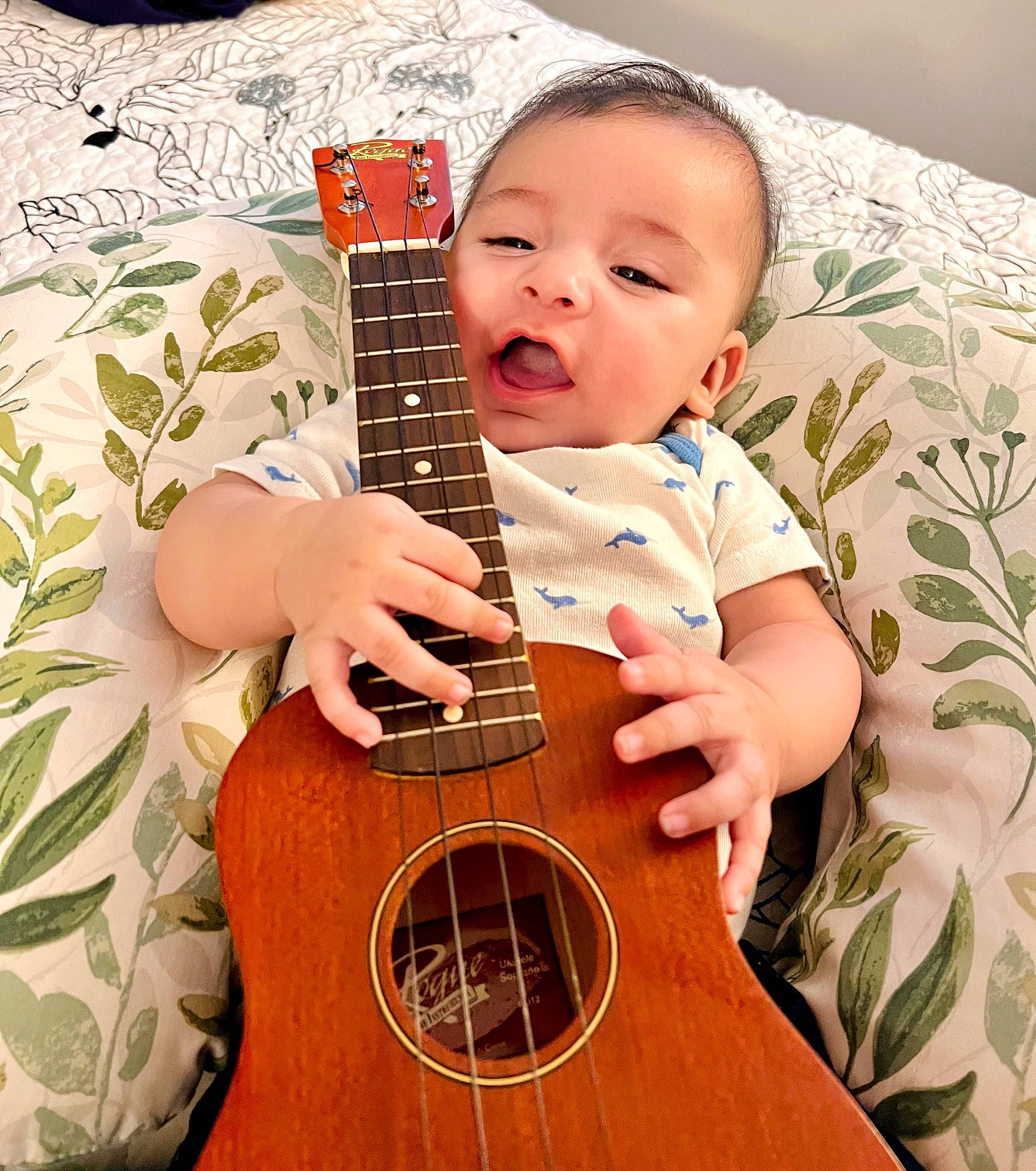 Gabriel is registered to the contest to win money with this photo: baby, baby_toddler_clothing, finger, folk_instrument, guitar, guitar_accessory, happy, music, musical_instrument, musical_instrument_accessory, musician, nail, peach, people_in_nature, person, plucked_string_instruments, string_instrument, string_instrument_accessory, toddler, wood