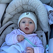 Léonie participe au concours pour gagner de l'argent avec cette photo : baby, blanket, blue_eyes, bundle, child, coat, cold_weather, cute, expression, face, hand, hat, infant, knit_hat, newborn, outdoor, portrait, snug, stroller, warm_clothing