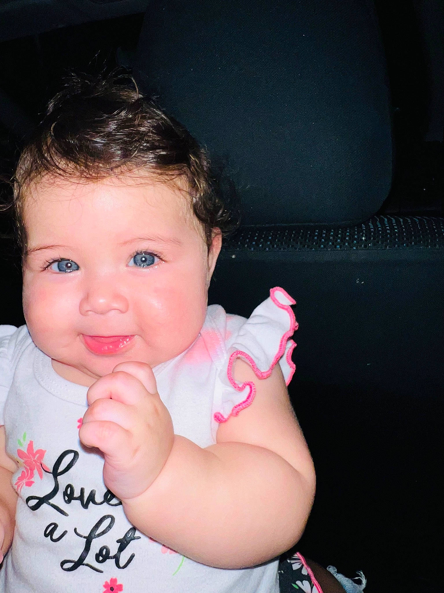 Samara is registered to the contest to win money with this photo: arm, baby, baby_toddler_clothing, cheek, ear, eyelash, finger, flash_photography, gesture, hand, happy, lip, mouth, nose, person, pink, skin, sleeve, steering_wheel, thumb