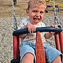 Lyvio a rejoint le concours — aidez-le/la à gagner de superbes lots ! child, toddler, swing, playground, outdoor, happy, smiling, summer, park, trees, play_equipment, chain, casual_clothing, shorts, tshirt, legs, grip, fun, recreation, daytime