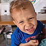 Lyvio a rejoint le concours — aidez-le/la à gagner de superbes lots ! child, toddler, indoor, blue_shirt, playing, smiling, face, person, furniture, table, chair, dartboard, stairs, wooden_floor, expression, hair, hand, knee, home, casual