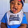 toddler, baby, child, head_wrap, blue_shirt, bib, indoor, happy, open_mouth, hands, expression, portrait, face, skin, clothing, lamp, door, cute, smiling, person