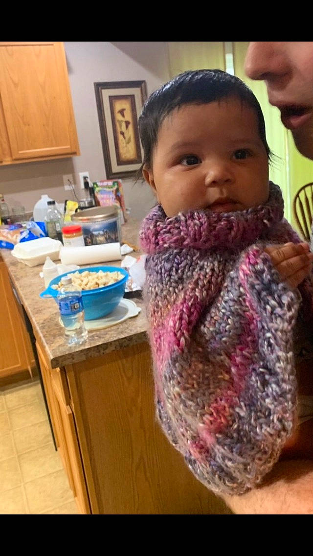 Karmyn is registered to the contest to win money with this photo: art, baby, cheek, child, crochet, face, knitting, neck, outerwear, person, scarf, textile, thread, toddler, wool