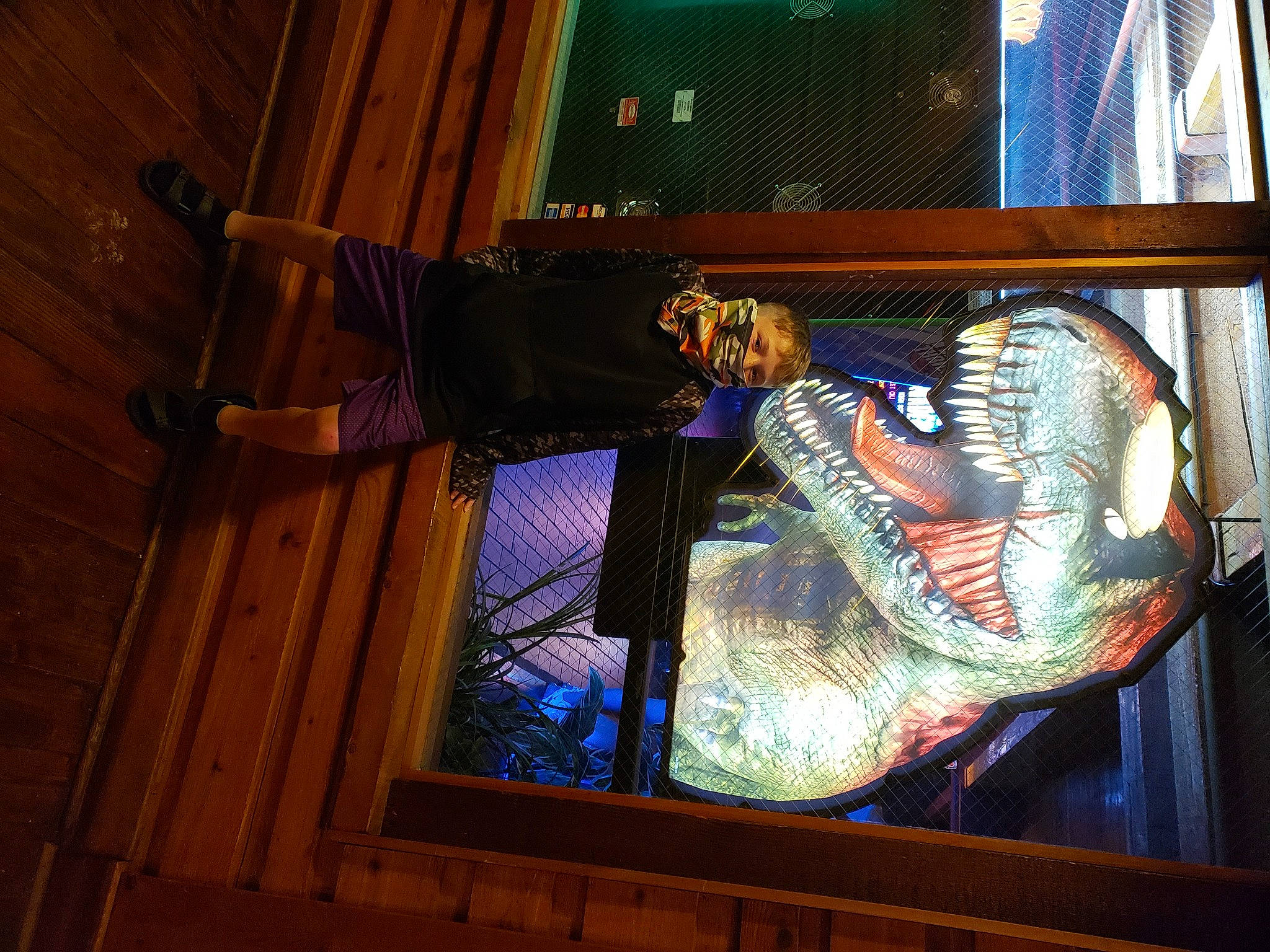 Brycen is registered to the contest to win money with this photo: art, darkness, display_device, flooring, fun, glass, hardwood, human_leg, machine, person, room, shoe, space, stained_glass, tints_and_shades, visual_arts, window, wood