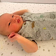 Carter joined the competition — help win amazing prizes! baby, infant, child, lying_down, sleeping, awake, face, portrait, onesie, gray_clothing, mattress, crib, bedding, stars, nursery, indoor, cozy, hands, peaceful, closeup
